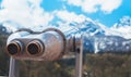 Touristic telescope look at the city with view snow mountains, metal binocular on background viewpoint observe vision, closeup Royalty Free Stock Photo