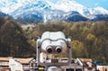 Touristic telescope look at the city with view snow mountains, metal binocular on background viewpoint observe vision, closeup Royalty Free Stock Photo