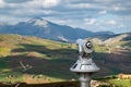 The touristic telescope at lookout where tourists can observe Sicilian landscape with cloud shadows