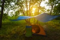 Touristic tent under a tarp in forest at the sunset