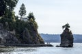 Touristis at siwash rock on stanley park seawall and cliff on a sunny summer day Royalty Free Stock Photo