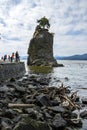 Touristis at siwash rock on stanley park seawall on a sunny summer day Royalty Free Stock Photo