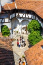 Tourists admire the Bran Castle also know as Dracula Castle near Brasov, Romania. Royalty Free Stock Photo