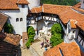 Tourists admire the Bran Castle also know as Dracula Castle near Brasov, Romania. Royalty Free Stock Photo