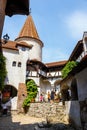 Tourists admire the Bran Castle also know as Dracula Castle near Brasov, Romania. Royalty Free Stock Photo