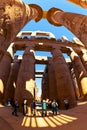 Tourists admire a magnificent architecture of the Great Hypostyle Hall of the Karnak Temple in Egypt Royalty Free Stock Photo