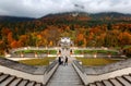 Tourists admiring beautiful scenery of majestic Linderhof Palace on the stairway in front of a baroque style garden Royalty Free Stock Photo