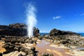 Tourists admiring the Nakalele blowhole on the Maui coastline. A jet of water and air is violently forced out through the hole in Royalty Free Stock Photo