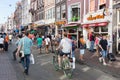 Tourists in Amsterdam shopping and looking for a restaurant Royalty Free Stock Photo