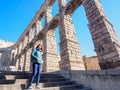 Tourists with ancient aqueduct, Segovia, Spain