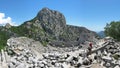 Tourists in ancient theatre at Termessos, huge mountain as a background