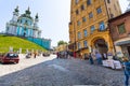 Tourists on Andriyivskyy Descent and Church