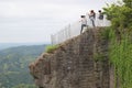 Tourists are approaching the edge of a cliff