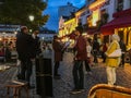 Tourists and artists in the Place de Tertre, Montmartre, Paris, at night