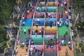 Tourists ascend the colorful stairs of the Batu Caves