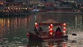 Tourists on an Asian chinese boat with red lanterns on a lake in Thailand