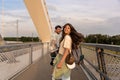 Tourists backpacker couple, Happy young travelers enjoying vacation together on sunset in new city. Stylish man and woman in Royalty Free Stock Photo