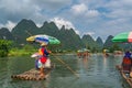 Tourists on bamboo rafts on Yulong River in Yangshuo