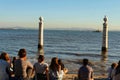 Tourists on the banks of Tagus river in Lisbon Royalty Free Stock Photo