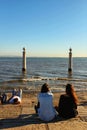 Tourists on the banks of Tagus river in Lisbon Royalty Free Stock Photo