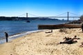 Tourists on the banks of Tagus river in Lisbon