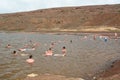 Tourists bathing in the salt crater lake. Pedra de Lume. Sal island. Cape Verde Royalty Free Stock Photo