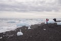 Tourists at the beach at Jokulsarlon glacier lagoon, Iceland