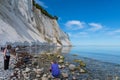 Tourists at the beach of Mons Klint chalk cliffs