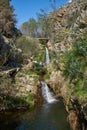 Tourists in beautiful waterfall in Penedo Furado Passadico walkway in Vila de Rei, Portugal