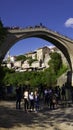 Tourists below and on the old bridge are waiting for a Bosnian diver to jump into the river Neretva. Mostar, Bosnia Royalty Free Stock Photo