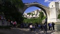 Tourists below and on the old bridge are waiting for a Bosnian diver to jump into the river Neretva. Mostar, Bosnia Royalty Free Stock Photo