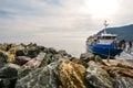 Tourists board a small tour boat on the Ligurian coast of Cinque Terre at the village of Monterosso Al Mare, Italy