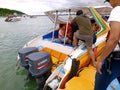 Tourists board a speedboat at the floating capital pier .