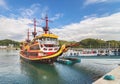 Tourists boarding on the Pirate Boat Mirai moored at the pier of the Kujukushima Pearl Sea Resort.