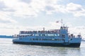 Tourists are boarding the Statue Cruises boat.