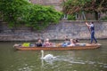 Tourists in the boat on the canal watching a swan, Cambridge, England, 21st of May 2017 Royalty Free Stock Photo