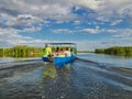 Tourists in a boat in the Danube Delta, Romania Royalty Free Stock Photo
