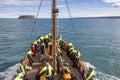 Tourists at boat for whale watching safari in artic sea, iceland Royalty Free Stock Photo