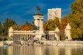 Tourists on boats at Monument to Alfonso XII in the Parque del Buen Retiro, Madrid