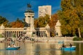 Tourists on boats at Monument to Alfonso XII in the Parque del Buen Retiro, Madrid