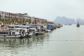 Tourists boats waiting for going to Halong bay with hotel in background in summer at Quang Ninh, Vietnam