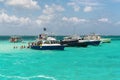 Tourists and boats at wild Stingray city on Gran Cayman, Cayman islands Royalty Free Stock Photo