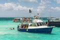 Tourists and boats at wild Stingray city on Gran Cayman, Cayman islands