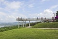 Tourists on view point on green hill with panorama location Royalty Free Stock Photo