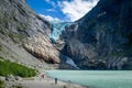 Tourists at Briksdalsbreen glacier viewpoint, Norway.