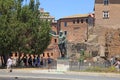 Tourists and bronze statue of emperor Caesar Augustus, Rome, Italy.