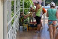 tourists buy from an elderly woman raspberry berries on the street