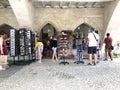 Tourists buying postcards and bracelets