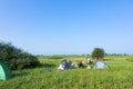 Tourists camping in the field, campground in the meadow