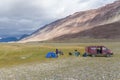 Tourists camping in Mongolian hills. Three tents under the open cloudy sky